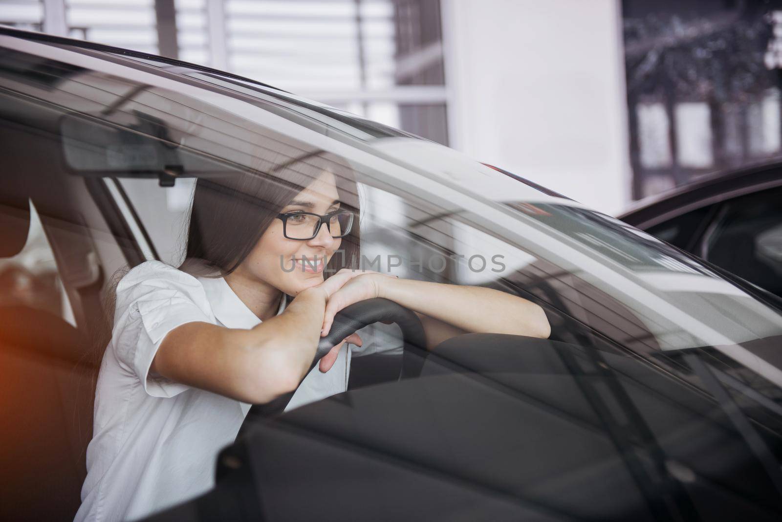 portrait of young beautiful woman sitting in the car.