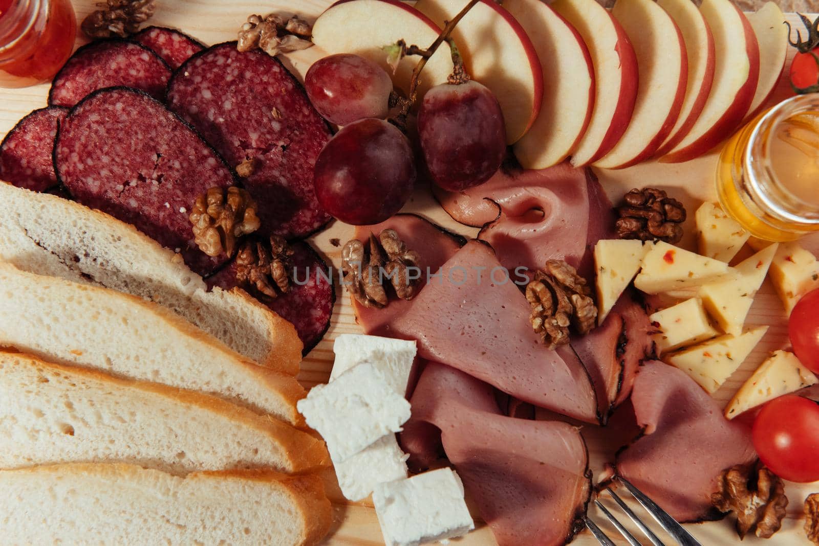 large wooden table meat, bread and vegetables.