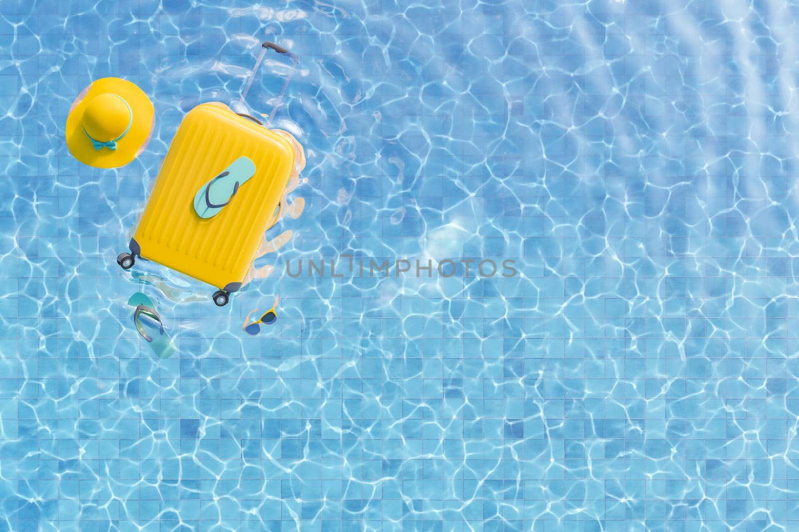 Top view 3D rendering of bright yellow suitcase with stylish hat sunglasses and flip flops floating in clear water of outdoor swimming pool in sunlight in summer