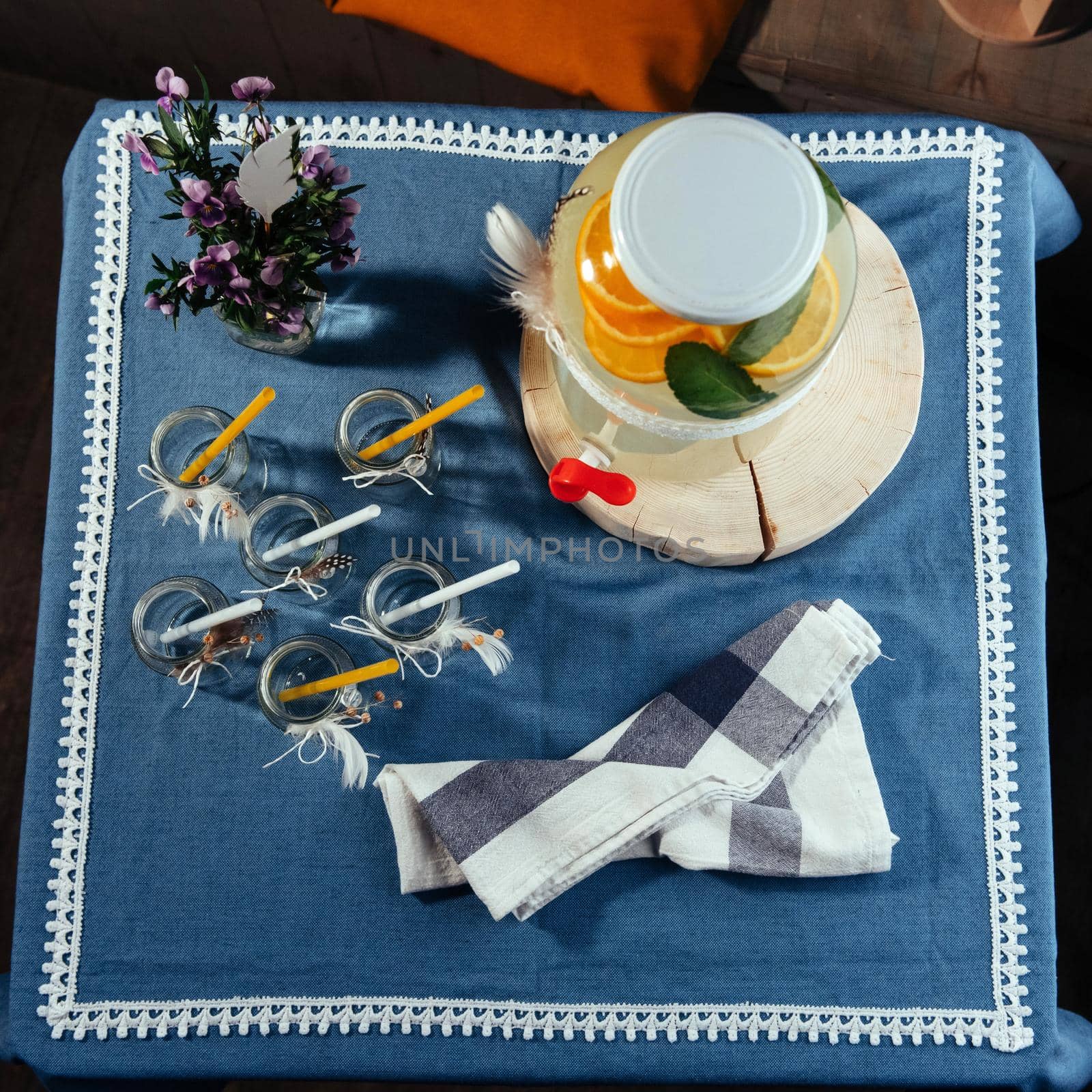 party drink station with small bottles and homemade lemonade.