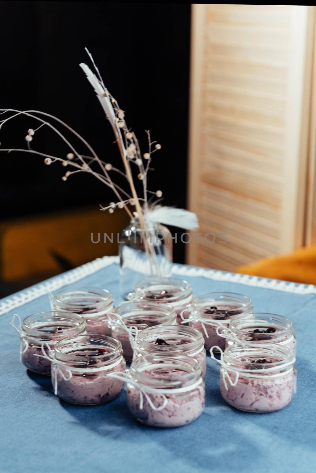 Blueberry dessert and fresh berries in a glass jar.