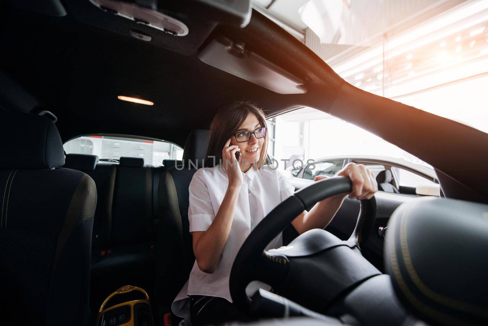 Businesswoman talking on the phone in the car.