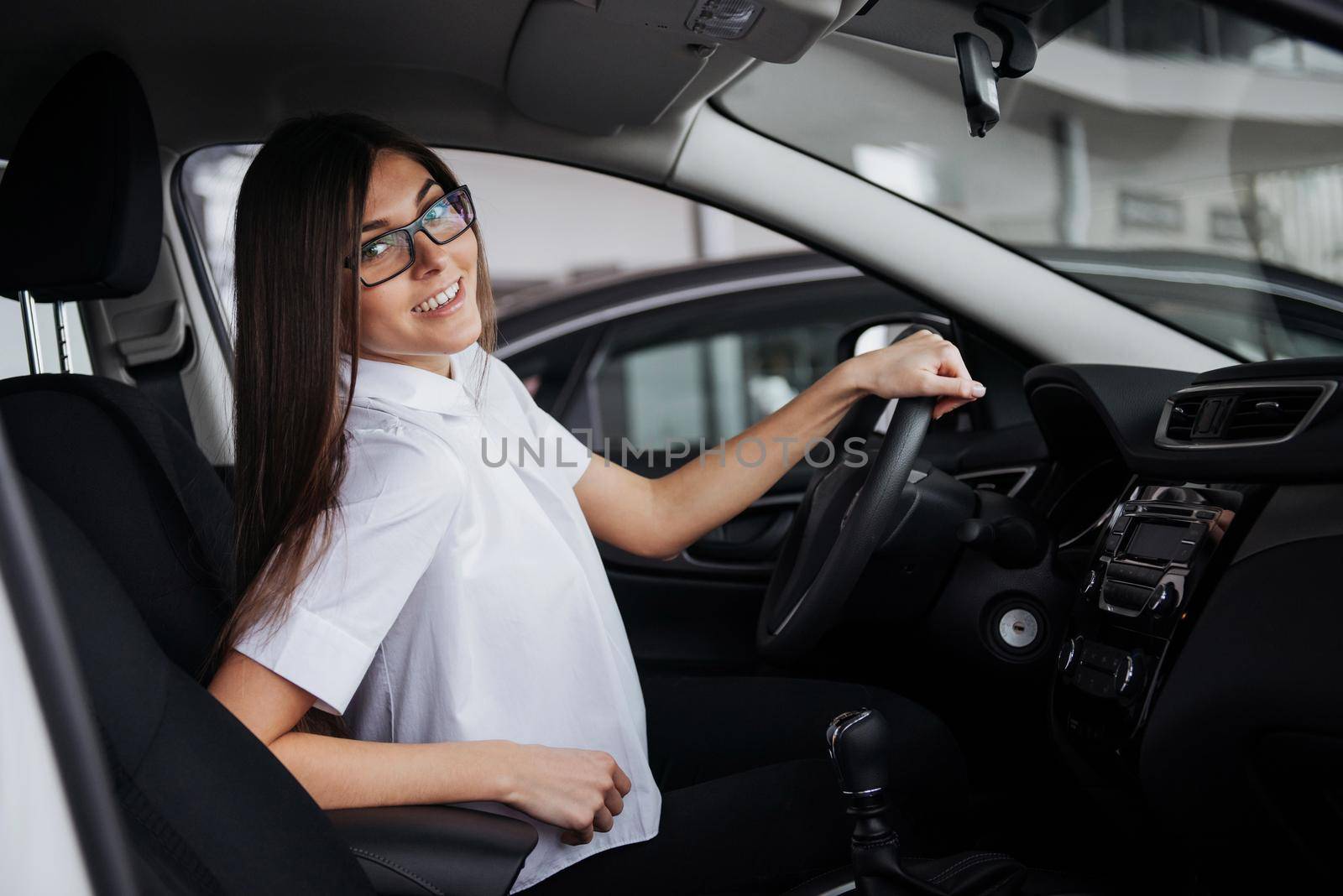 portrait of young beautiful woman sitting in the car.