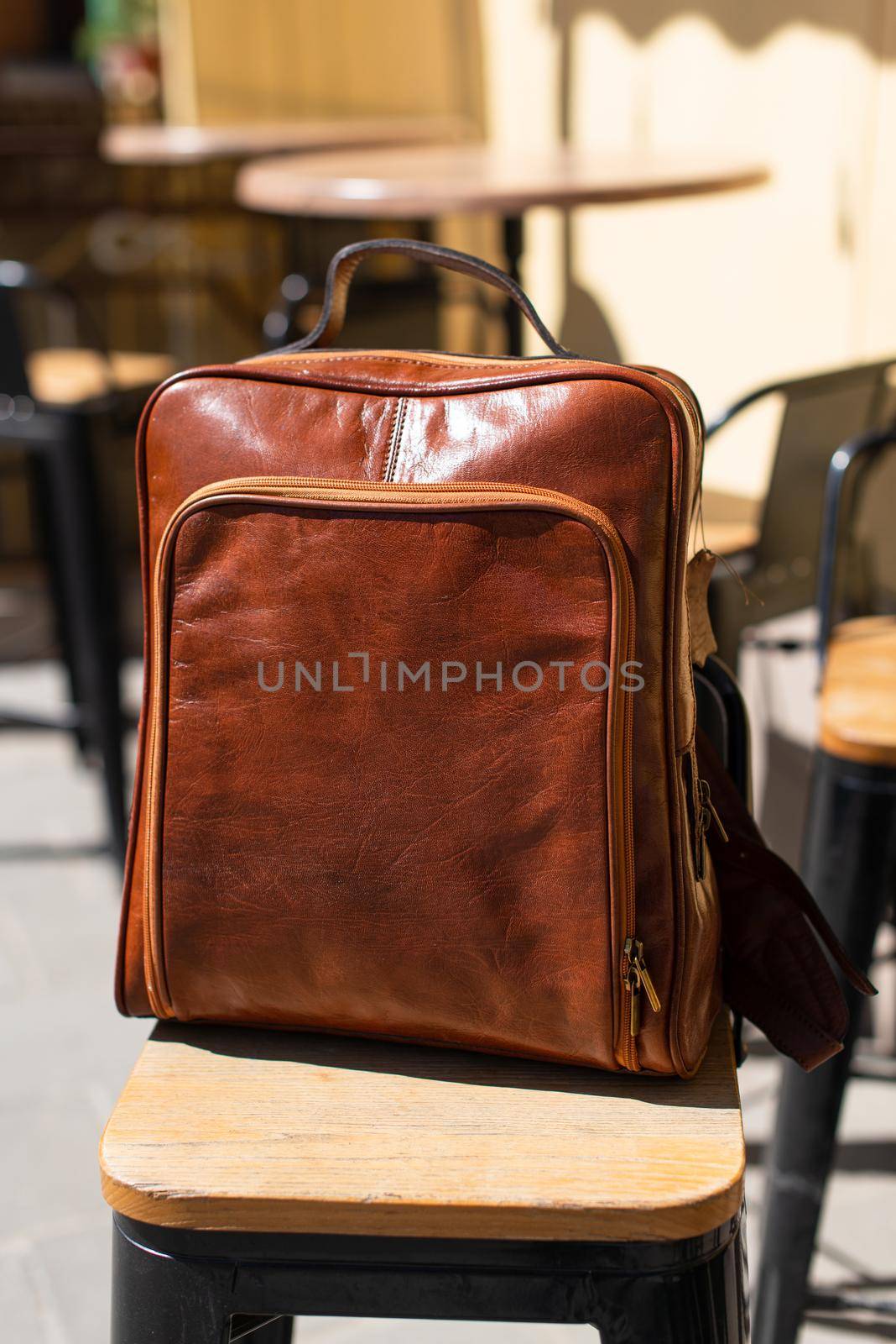Orange leather backpack. Street photo.