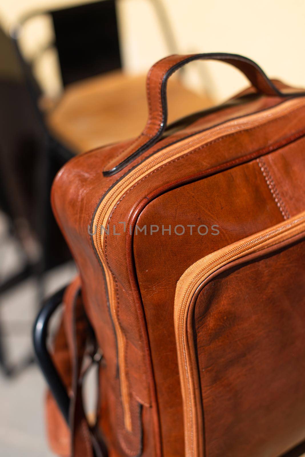 Orange leather backpack. Street photo.