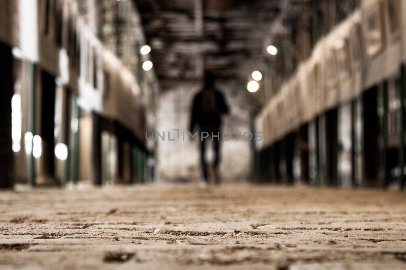 Corridor and a blurry person walking in a photography exposition in an old factory in Igualada