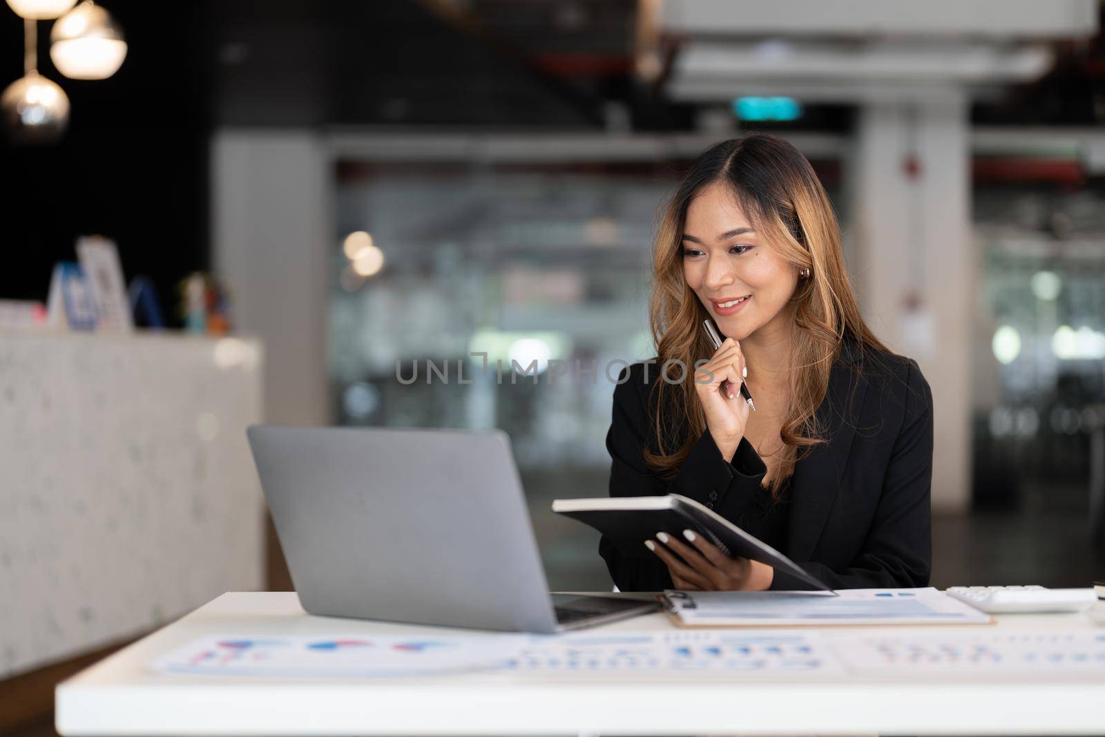 Young business asian woman working on laptop in office for accounting financial concept.