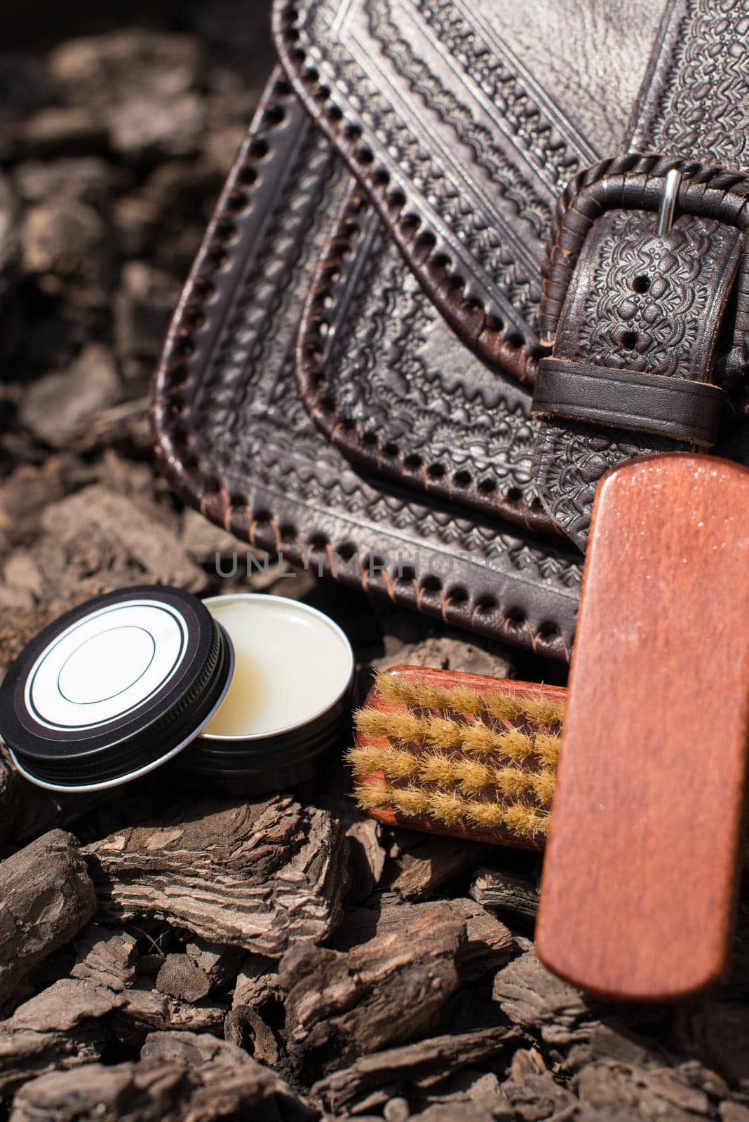 Wax and brush, leather maintenance concept. old genuine leather bag on a background. .