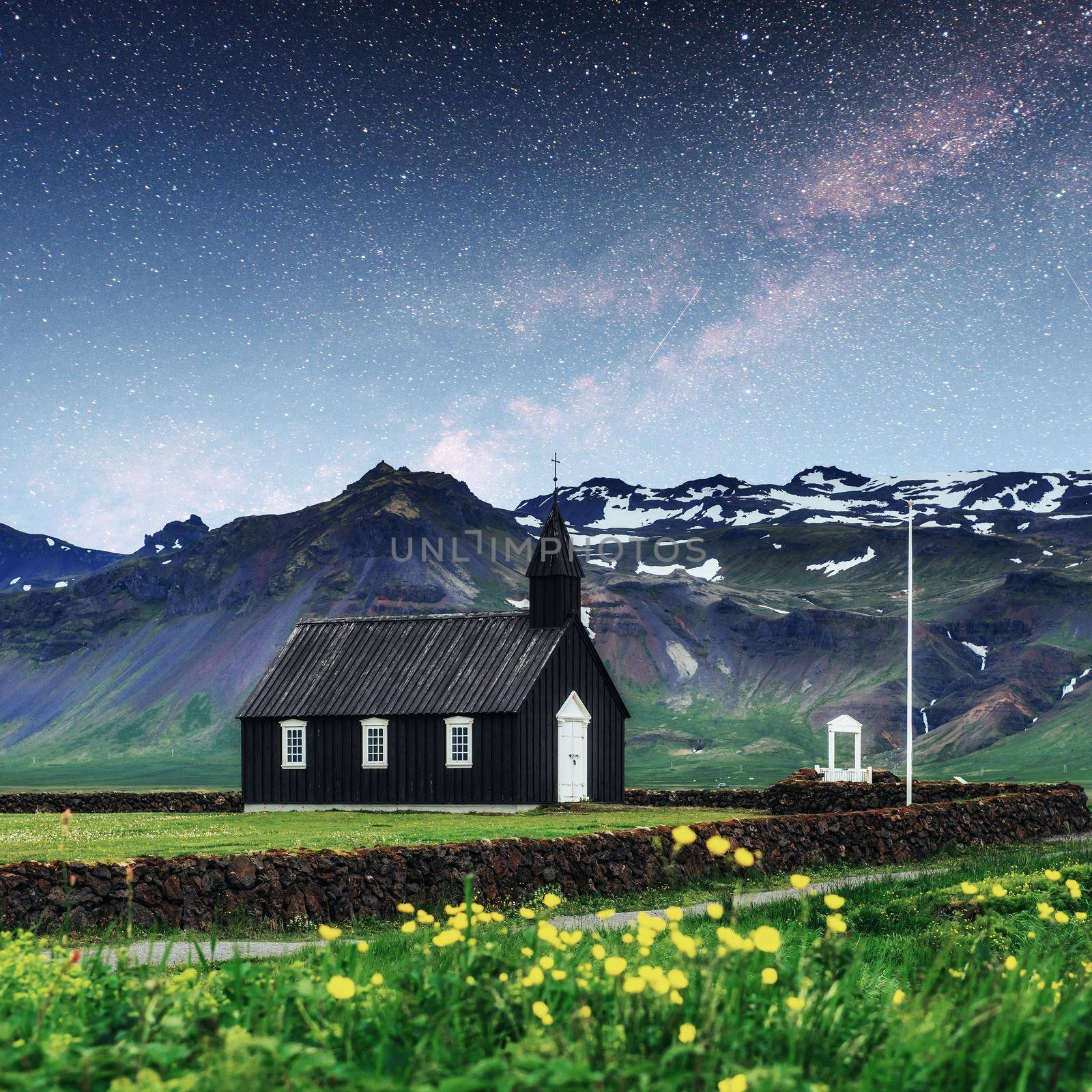 Mountain View Iceland. Fantastic starry sky and the milky way. Beautiful black wooden church in Budir.