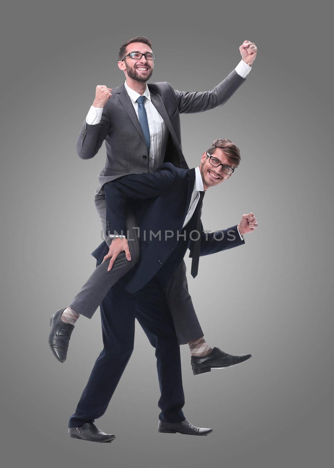 smiling businessman sitting on the back of his colleague . isolated on white background.