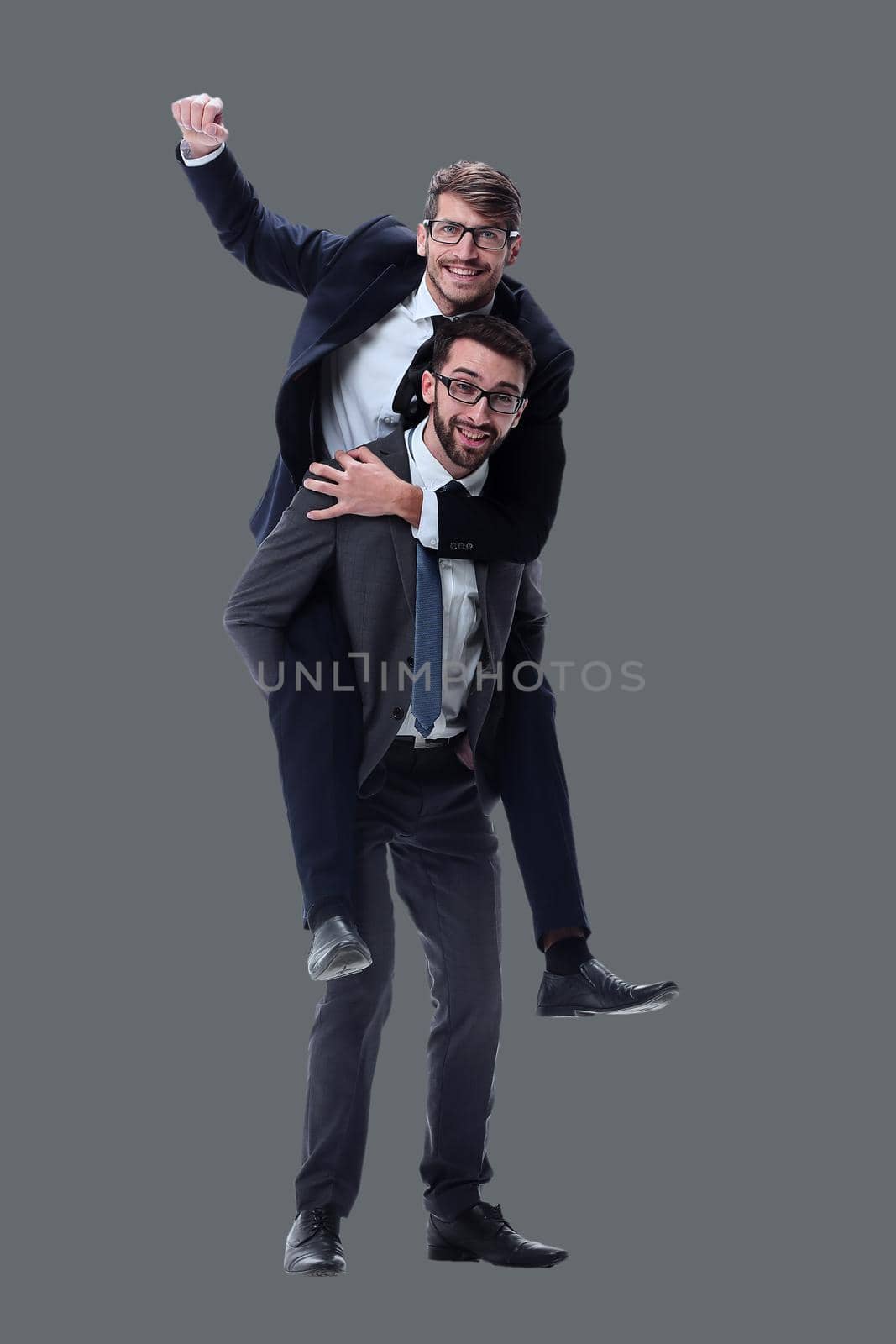 smiling businessman sitting on the back of his colleague . isolated on white background.