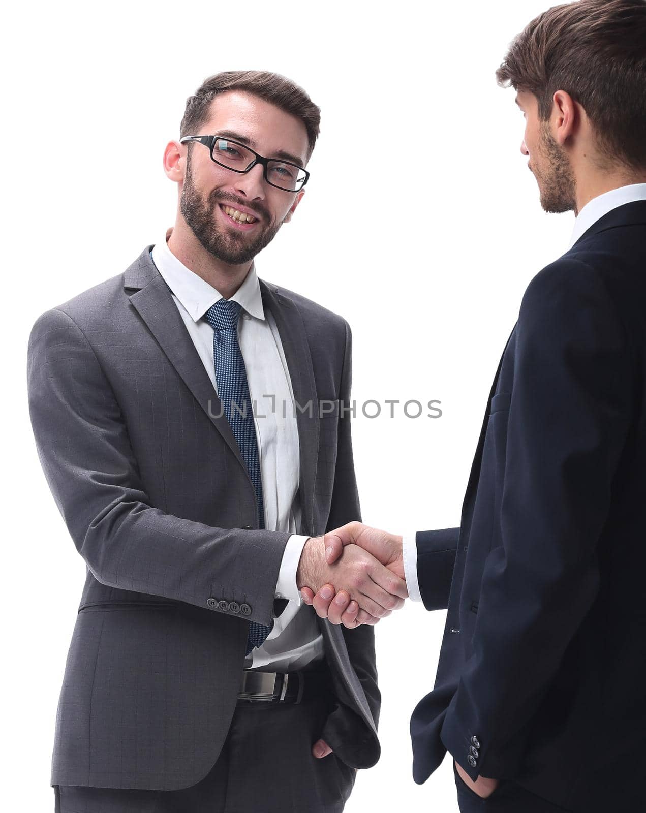 in full growth. business people shaking hands. isolated on white background