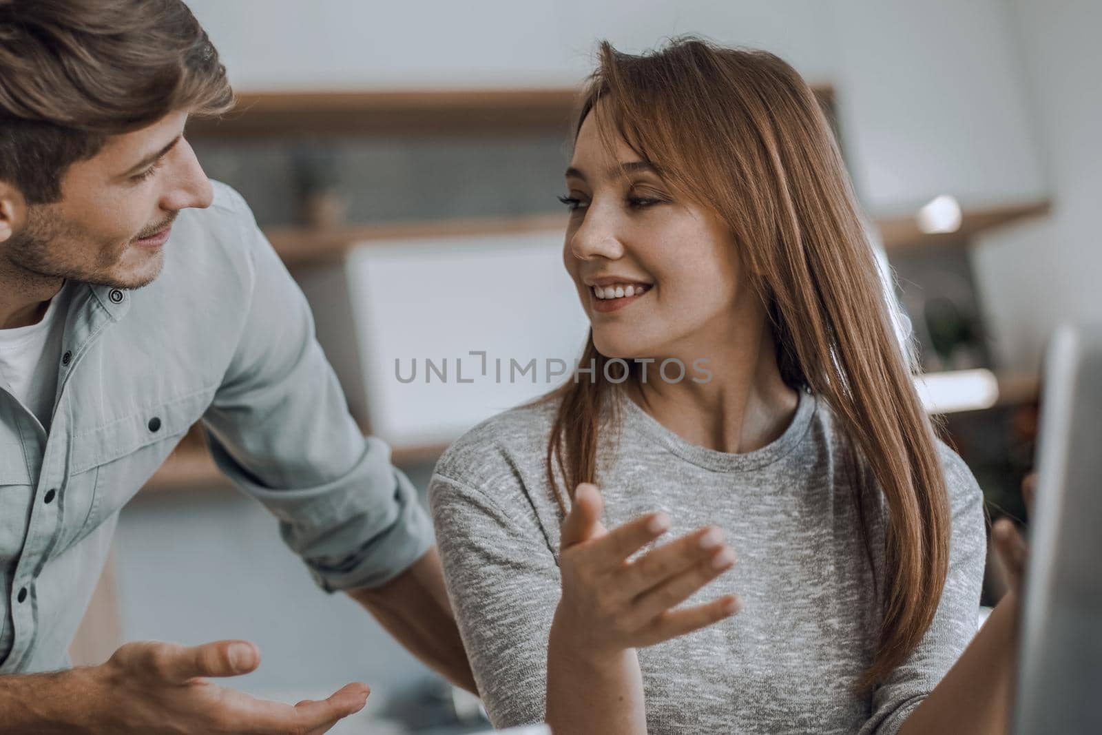 Cute couple using laptop together at home in the kitchen by asdf