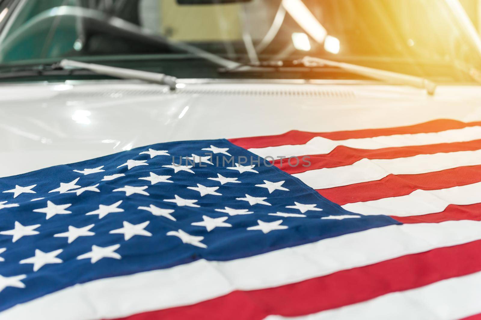 USA flag on the hood of a white car by cla78