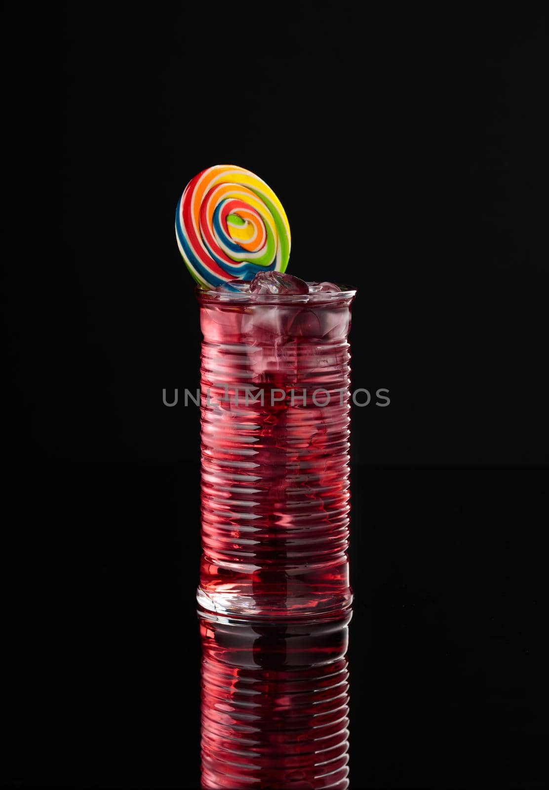 Cocktail in a glass on a black background vertical