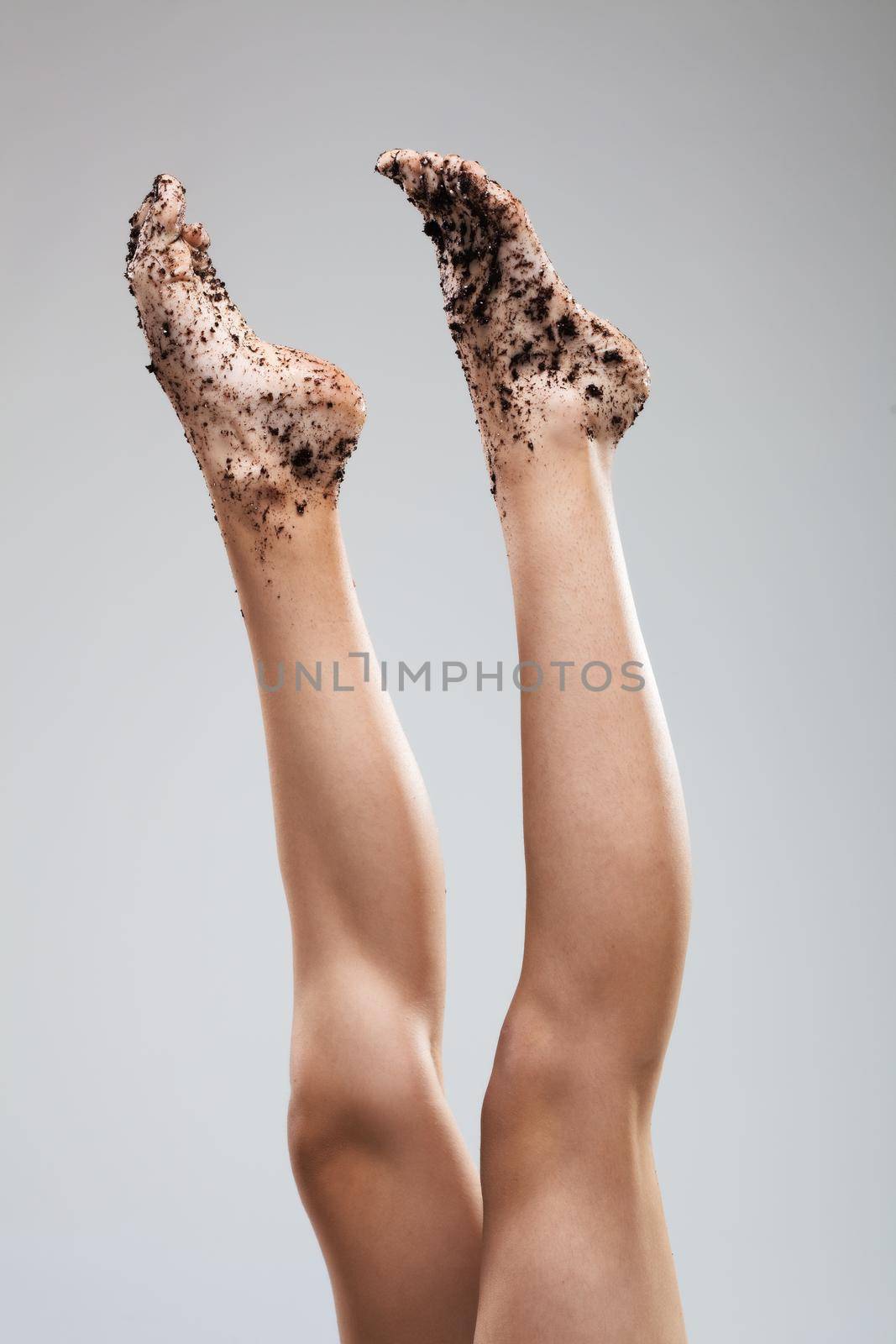 Sexy female legs. Feet covered with dirt.
