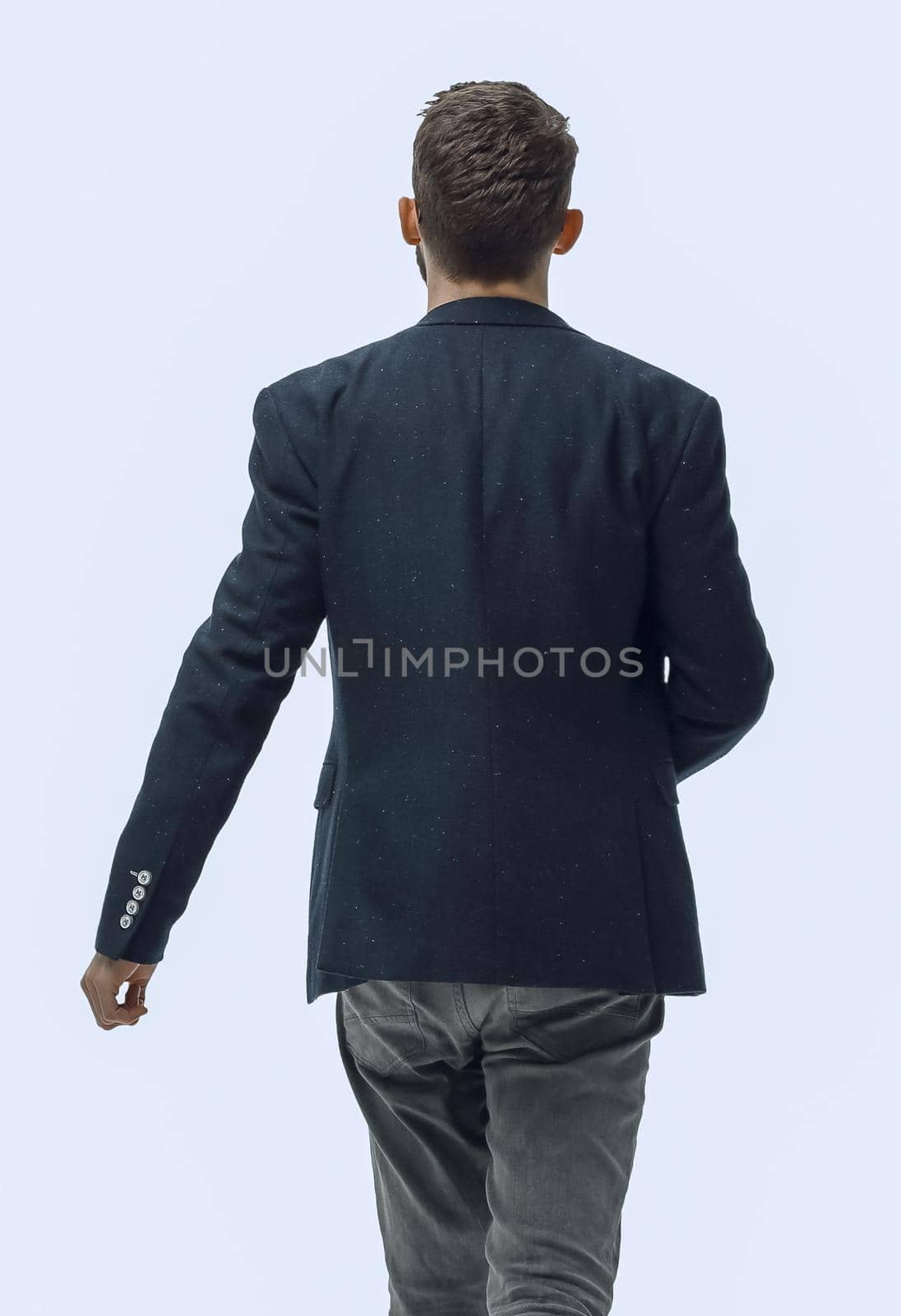 in full growth. successful modern man confidently stepping forward. isolated on white