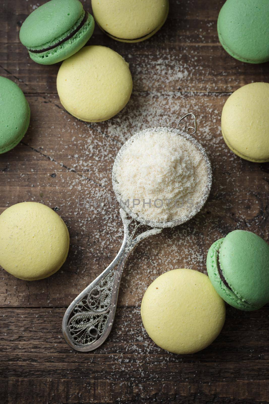 Pastel colored macaroons on a dark background with copyspace