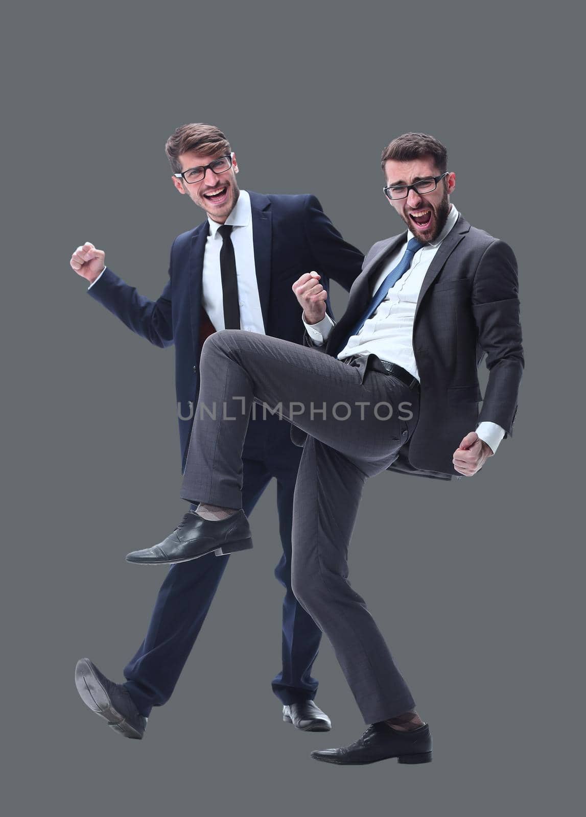 in full growth. two very happy young businessmen . isolated on white background.