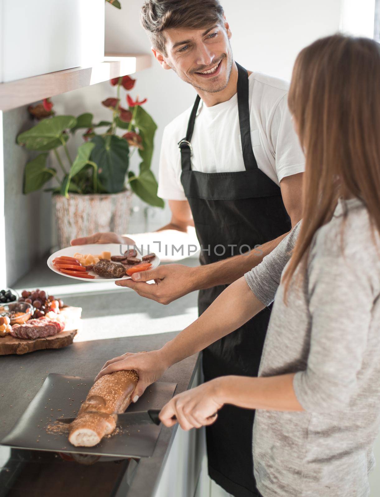 happy young couple standing in their new kitchen in the morning