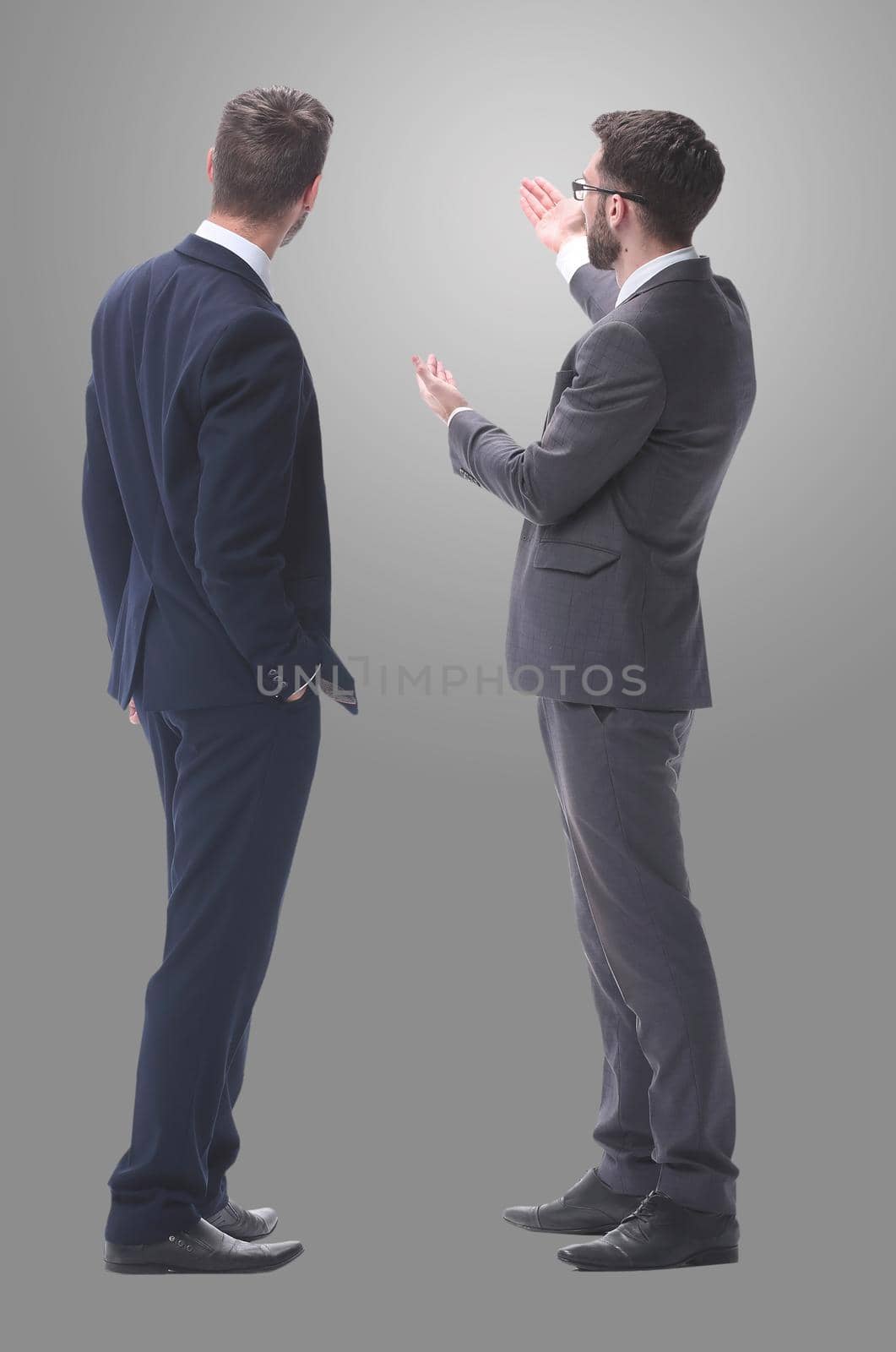 rear view. two businessmen looking at copy space. isolated on white background.