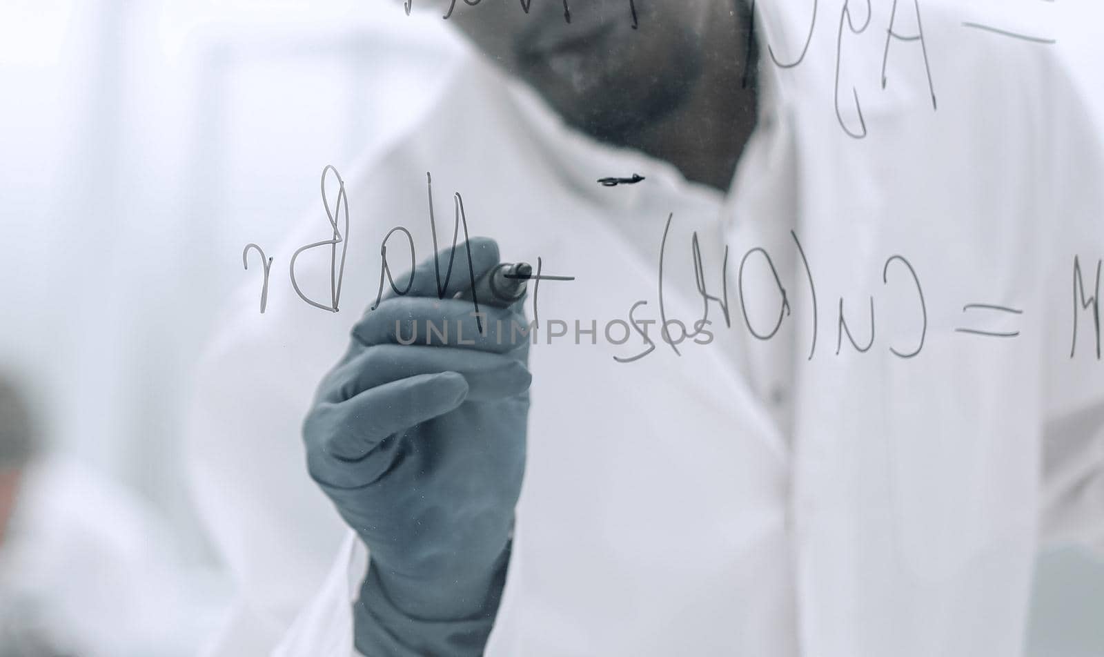 scientist writing chemical formula on a glass Board.photo with copy space