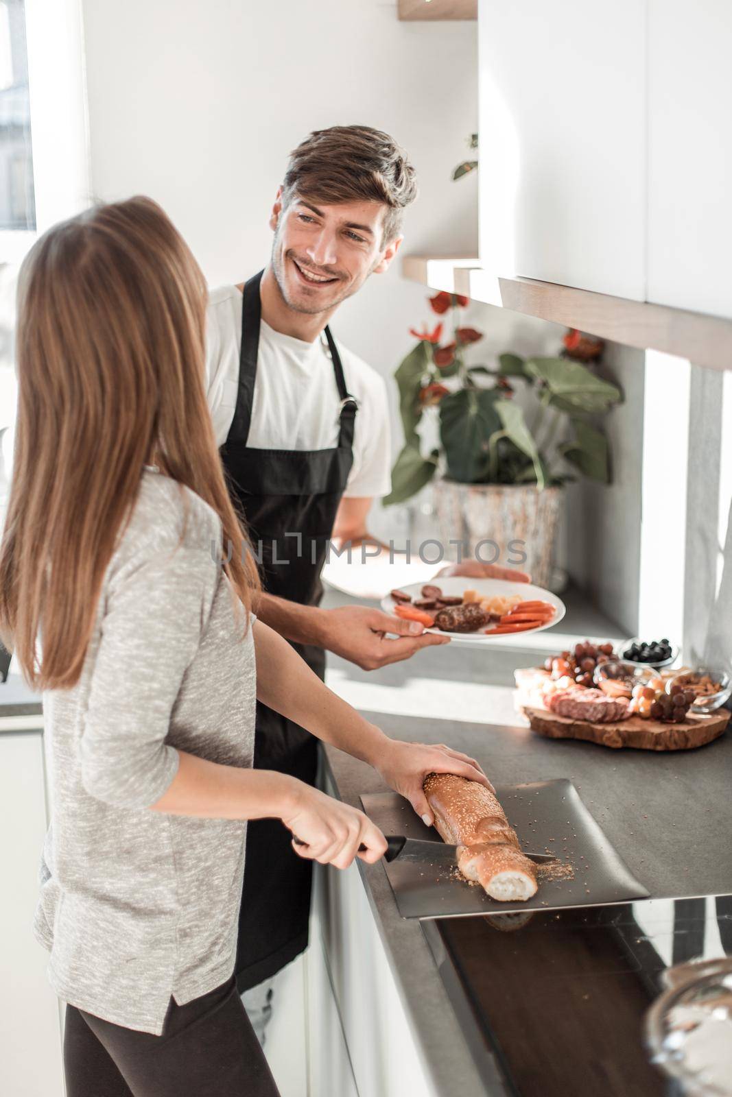 happy young couple standing in their new kitchen in the morning