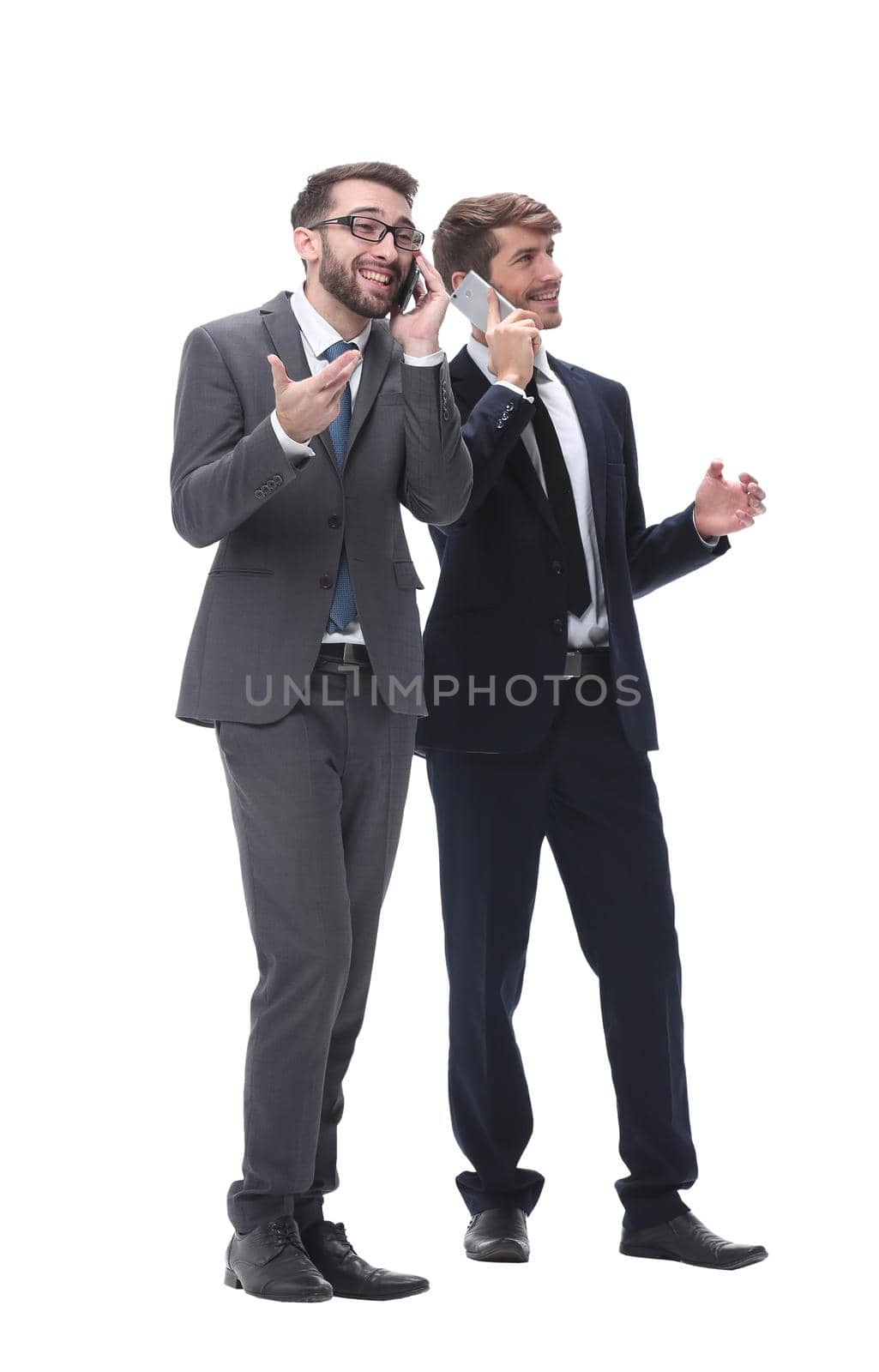 full length . two businessmen using their smartphones . isolated on white background