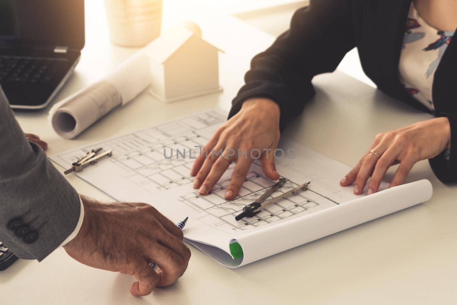 Architect and engineer working with construction drawing project on table in office. Architecture and engineering business concept.