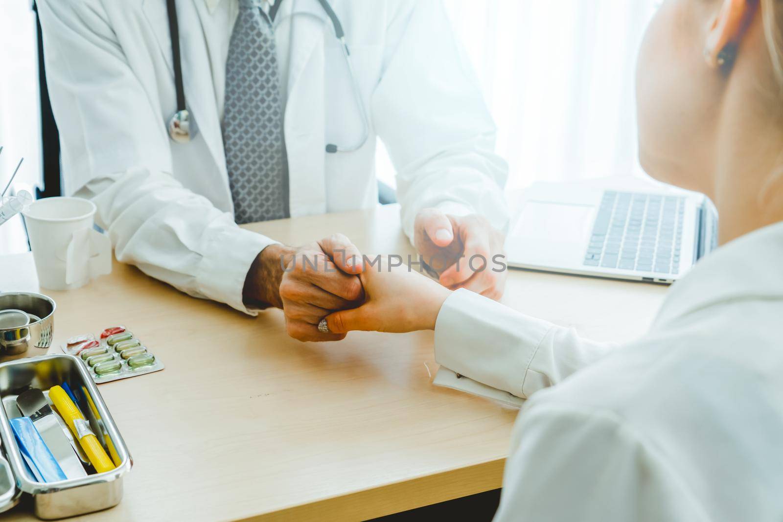 Doctor in professional uniform examining patient at hospital or medical clinic. Health care , medical and doctor staff service concept.