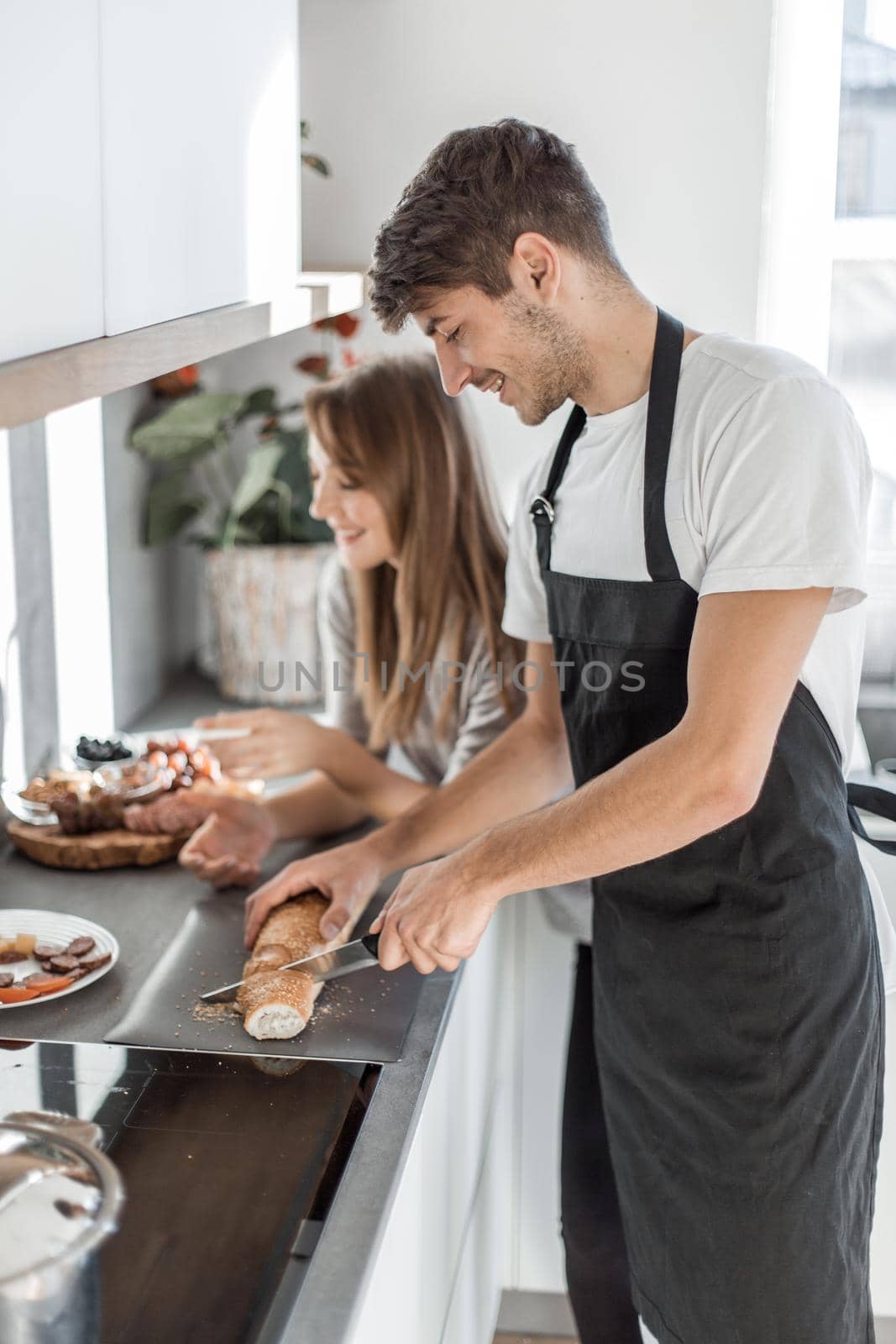 modern young couple having fun making sandwiches for Breakfast.