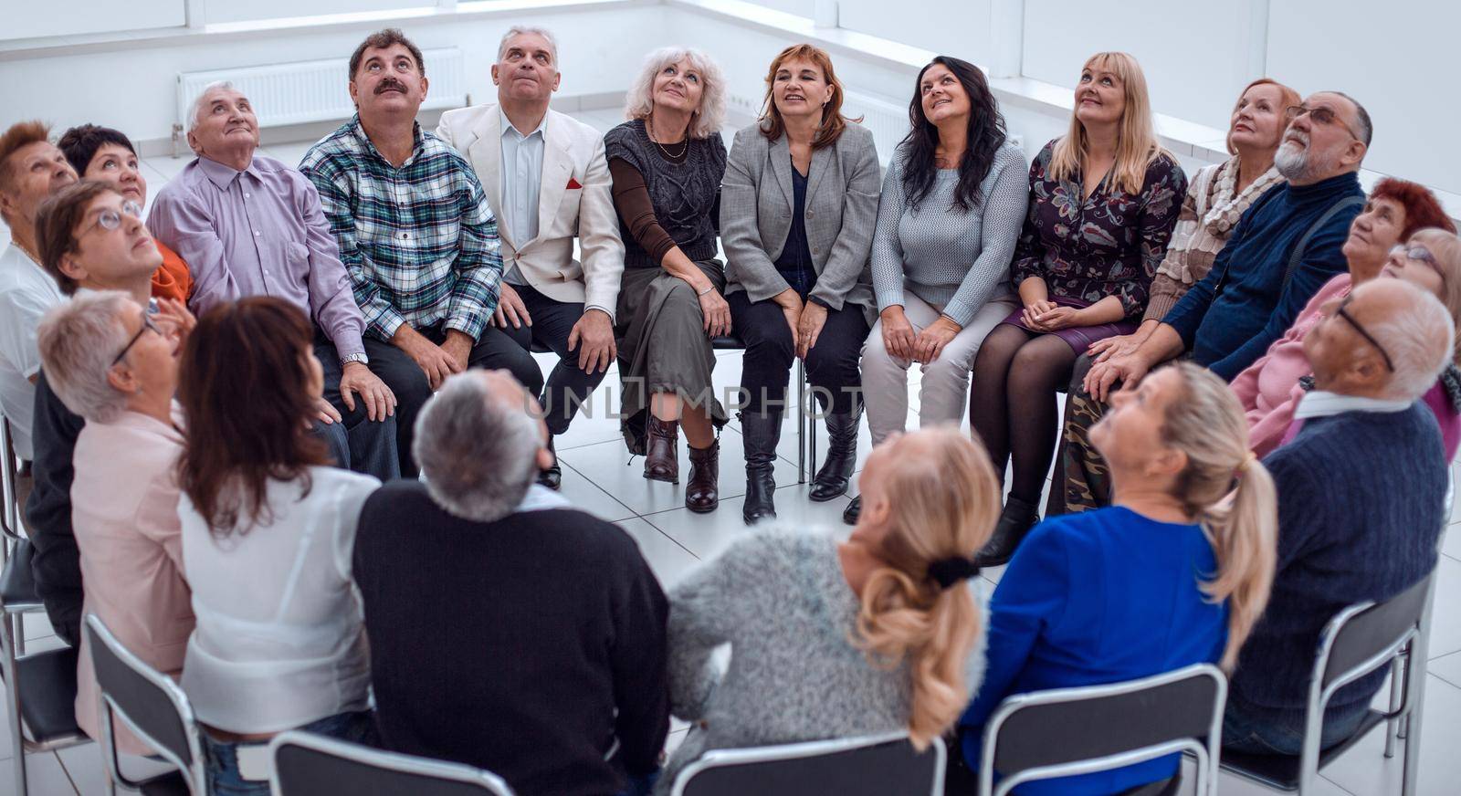 a group of mature mature people stretched their arms forward sit by asdf