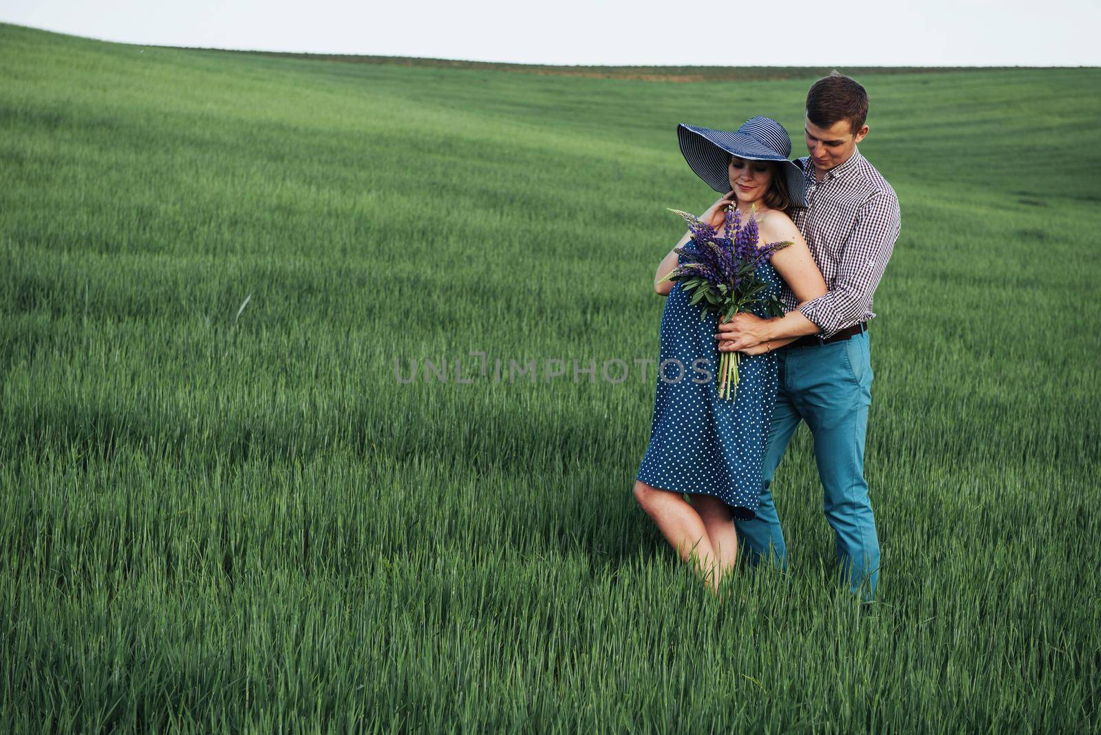 Happy couple awaiting baby. Beautiful and young parents by Standret