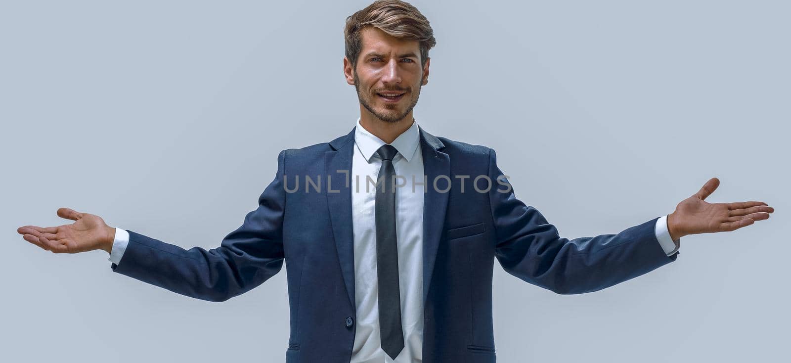 casual man with arm out in a showing gesture, isolated on white