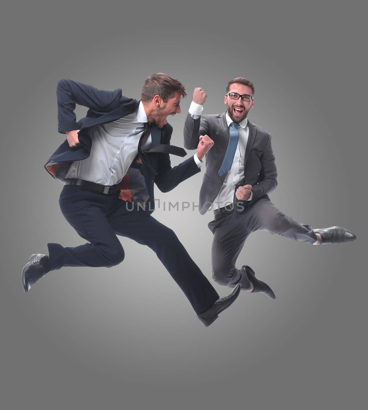 in full growth. two cheerful dancing business people. isolated on white background.