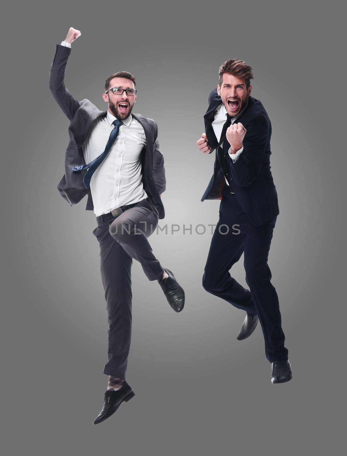 in full growth. two cheerful dancing business people. isolated on white background.