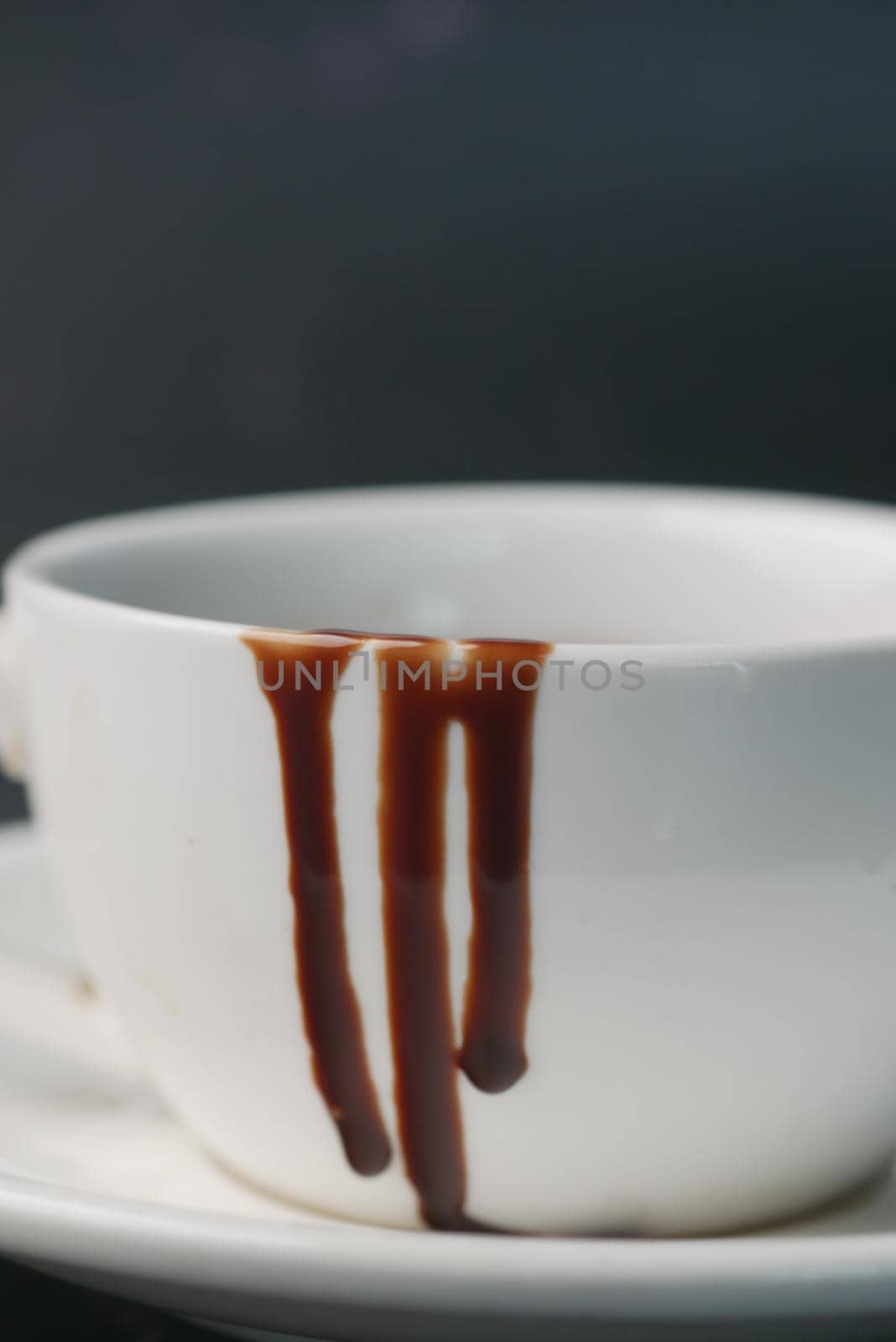 dark chocolate cream in a bowl on white .