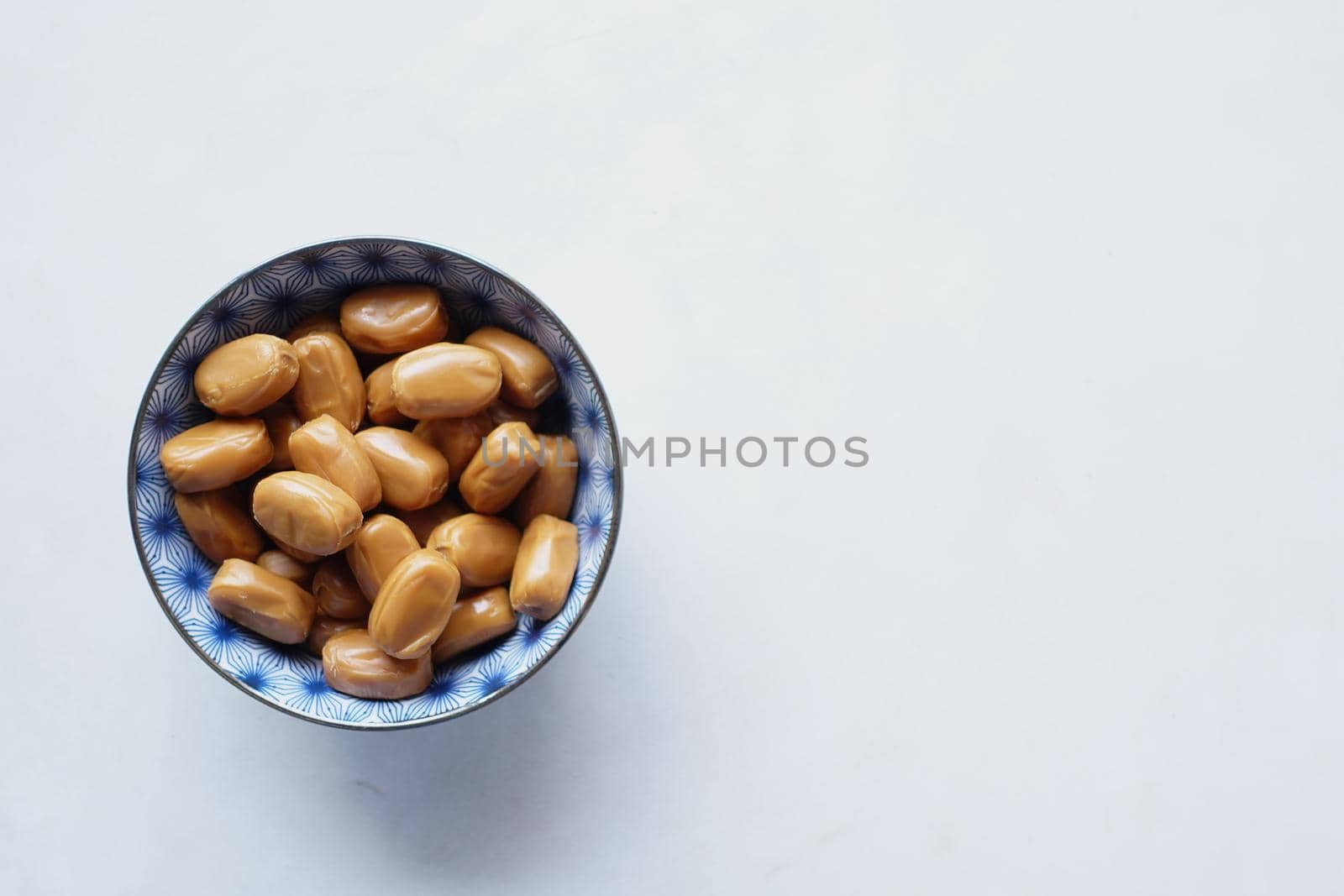 caramel chocolate bar in a bowl on white ,