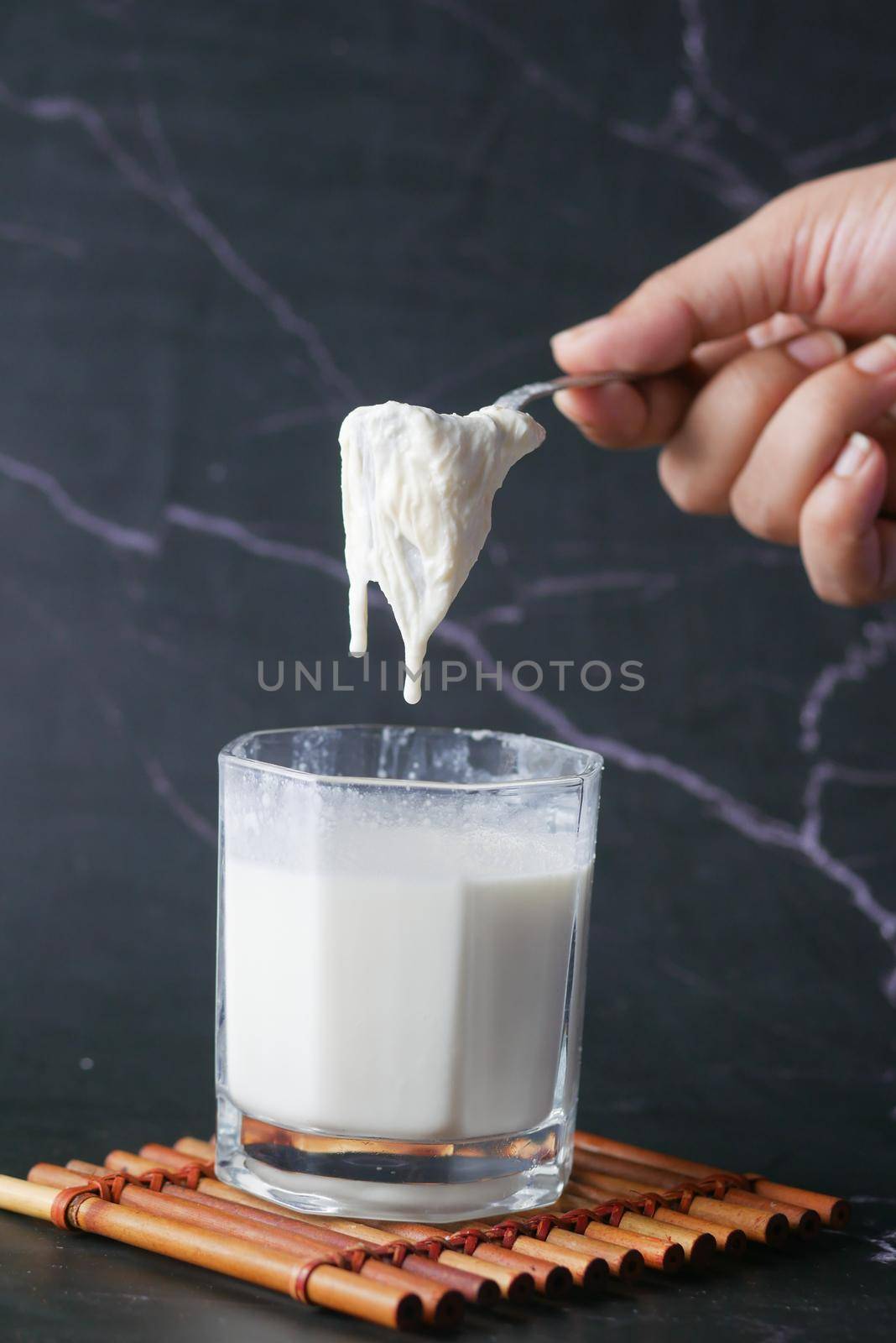 whole cream milk in a glass .