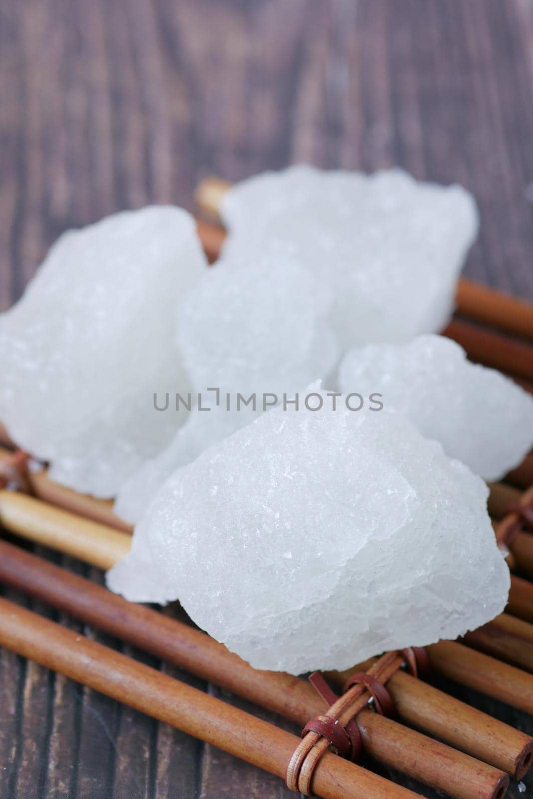 sugar candy on a wooden board on black background .