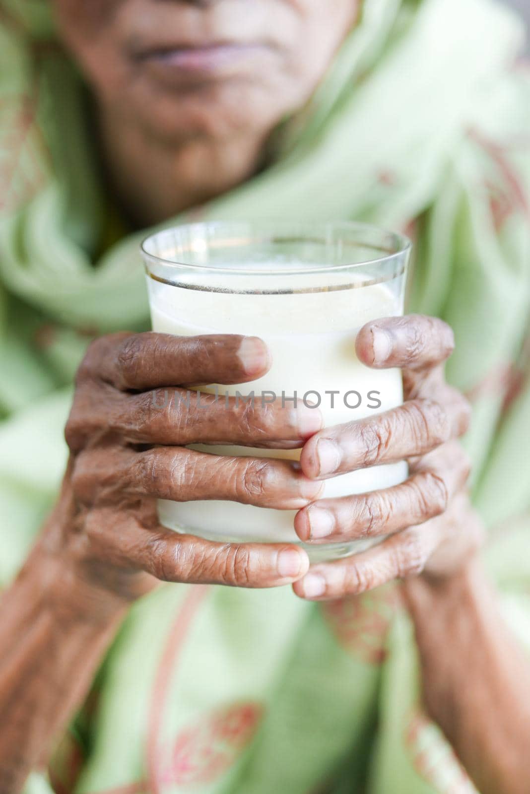 senior women hand holding a glass of milk ,