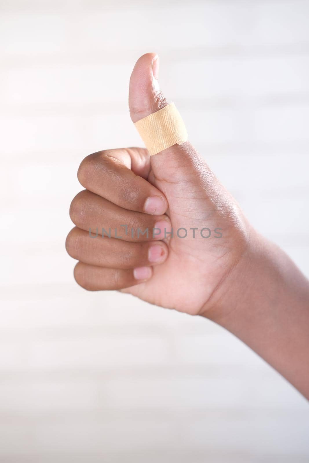 thumb finger with adhesive bandage wrapped around ..