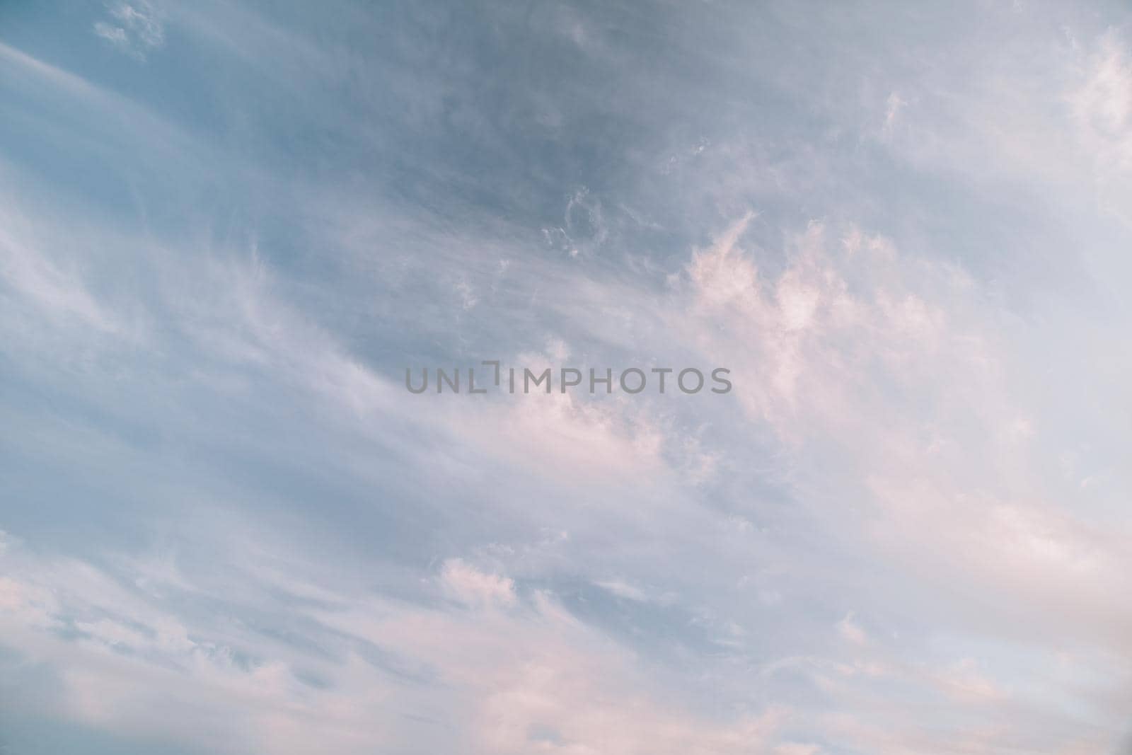Abstract aerial blue sky with light Cirrus clouds summer sunset background. Vacation, travel and holiday concept. by panophotograph