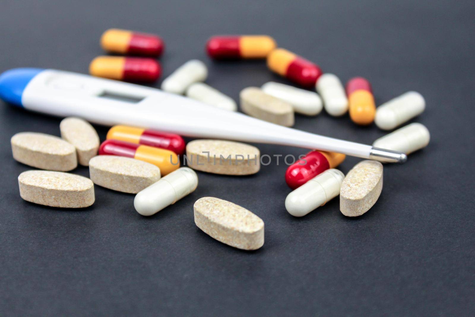 Medicine pills, tablets and thermometr on black background. by JuliaDorian