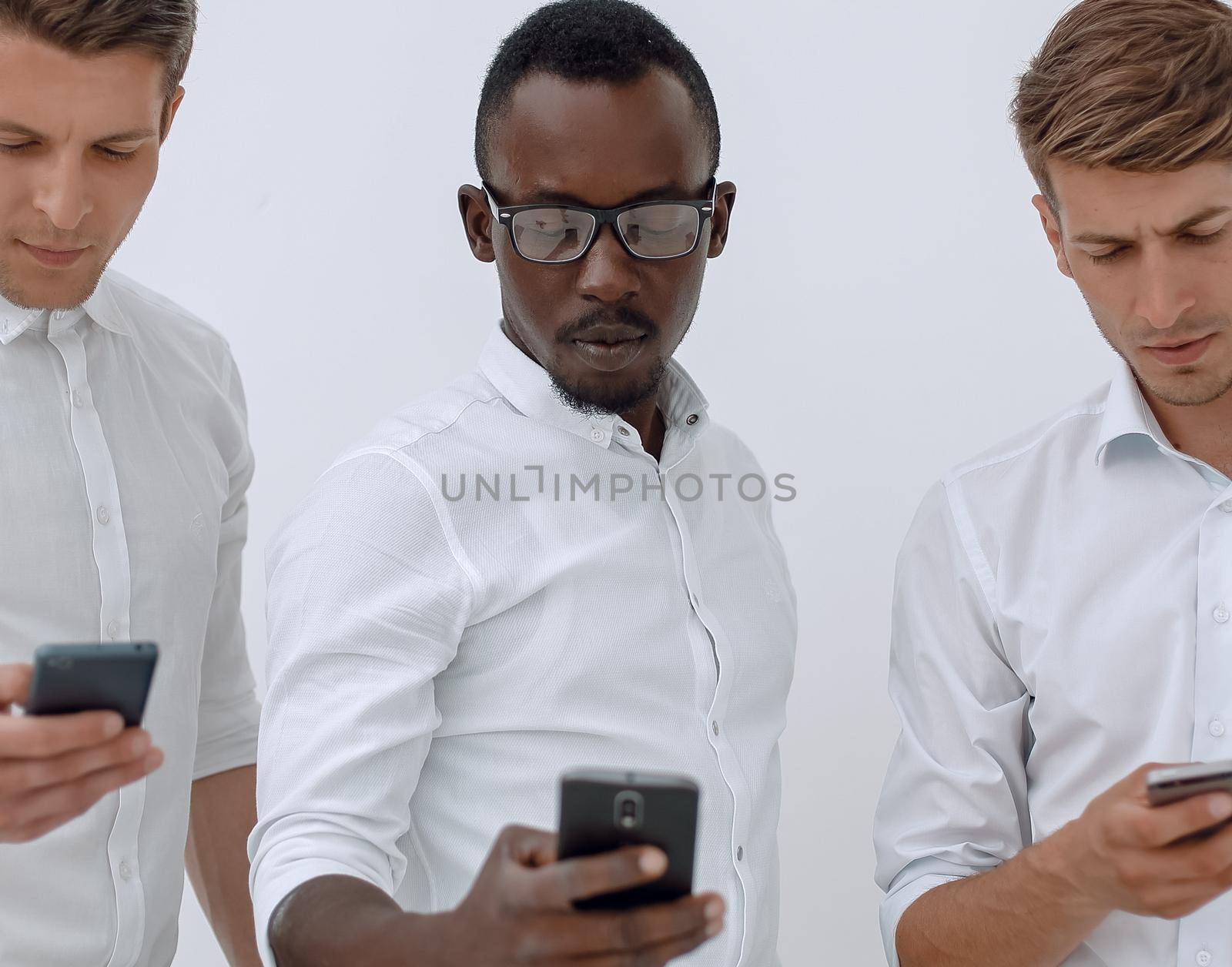 Group young multiethnic business people using mobile phones isolated over white background
