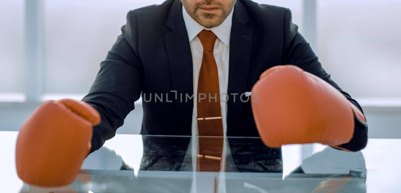 close up.responsible businessman Boxing gloves sitting at the Desk by asdf