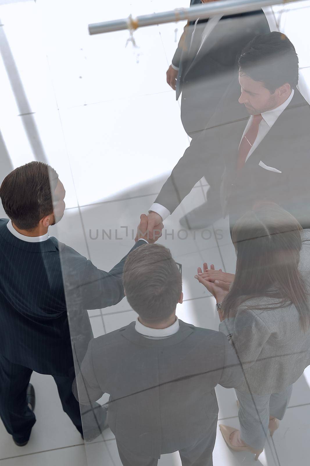 business background.handshake business men in the circle of employees. business concept