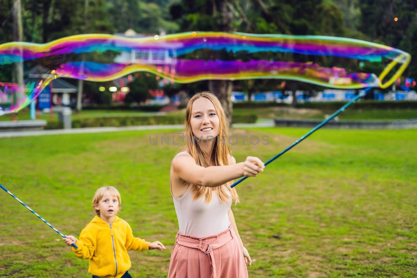 Happy carefree young woman blowing soap bubbles.