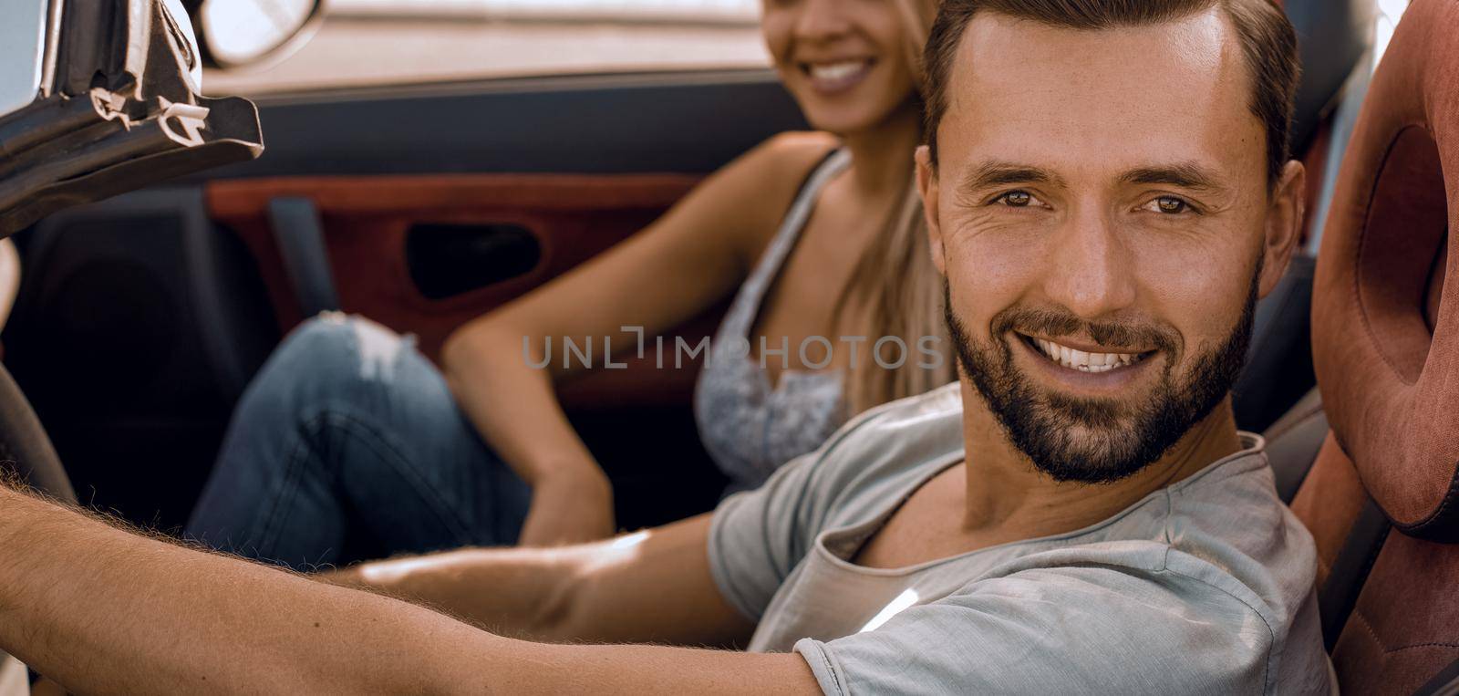 top view.a young man traveling in a convertible car.city life