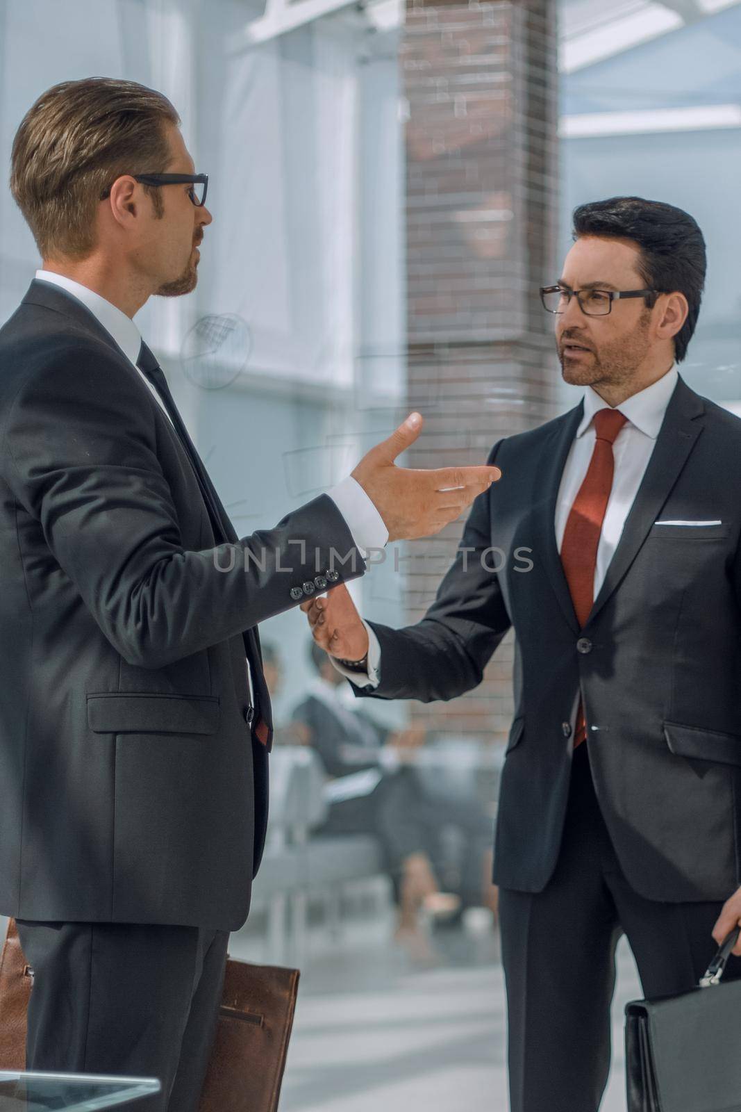 two businessmen talking in the office hall.the concept of business relationship